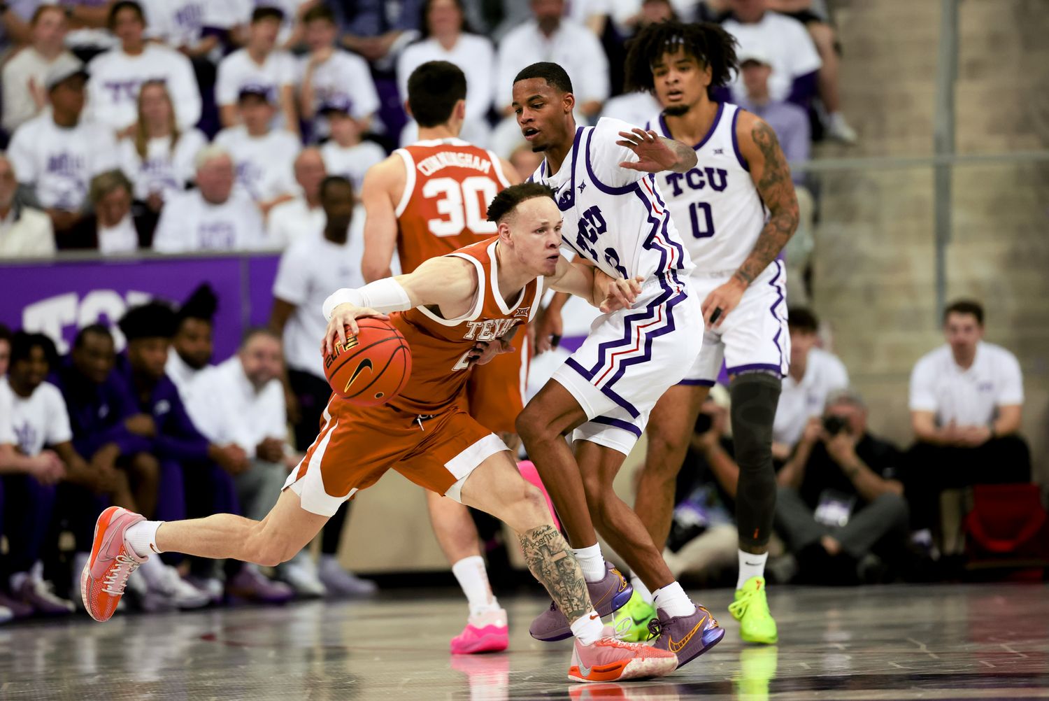 Texas Longhorns guard Chendall Weaver (2) controls the ball as TCU Horned Frogs guard Avery Anderson III (3) defends during the first half at Ed and Rae Schollmaier Arena.